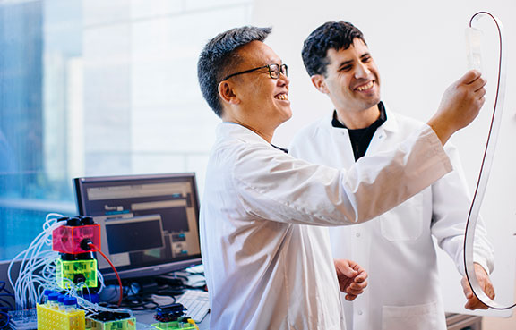 Two Lab Technicians Viewing Scientific Readings