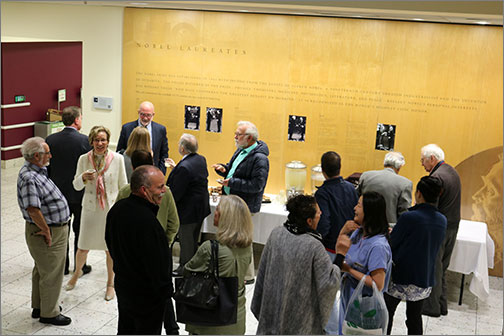 Attendees visit with Featherstone after his presentation